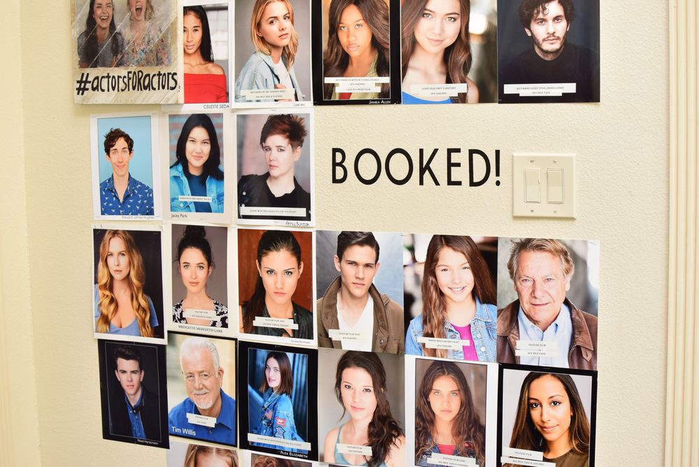 The BOOKED wall at The AFA Studio — student headshots covering the wall